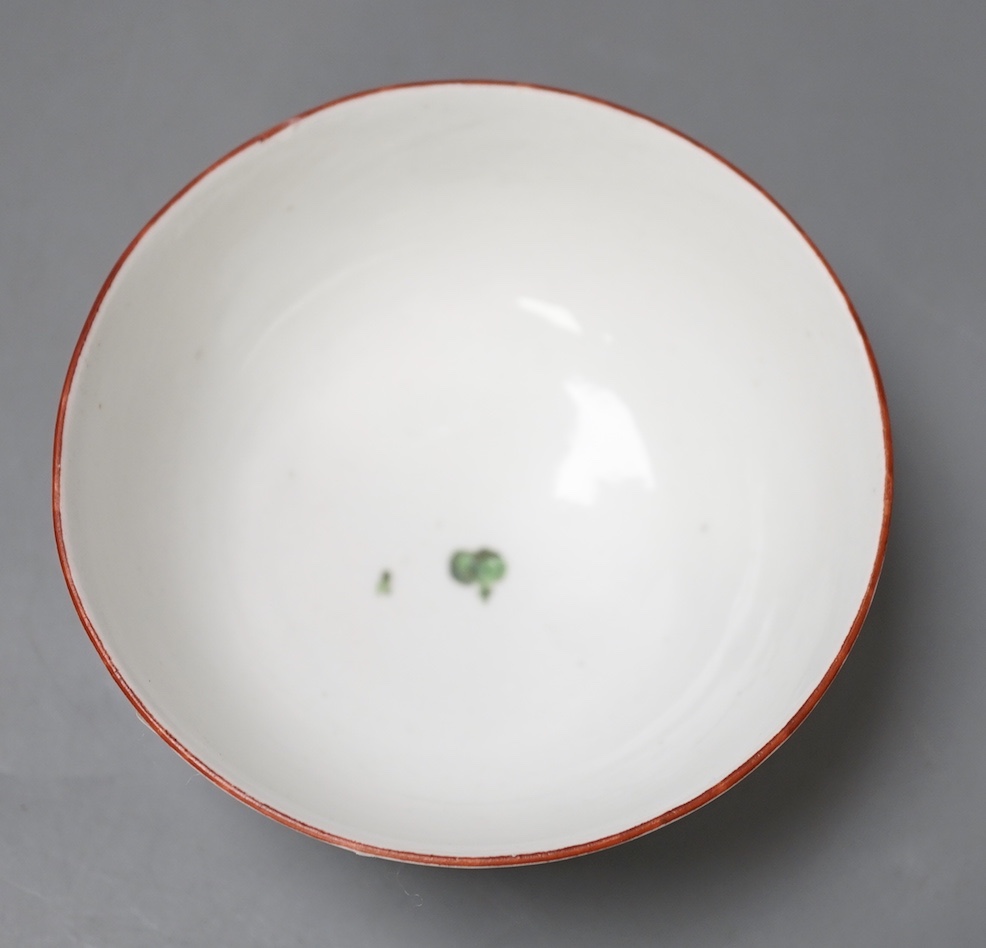 A Bristol porcelain bowl painted with a spray of flowers and scattered sprigs, crossed swords dot mark in under-glaze blue c.1775
